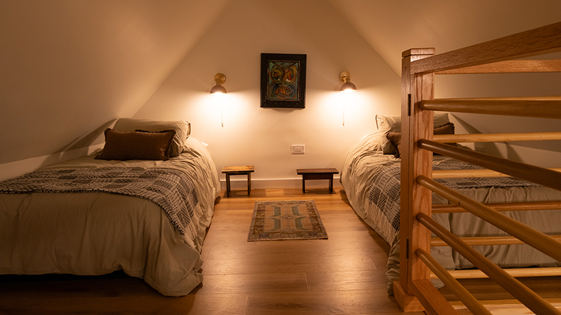 Rooted woodland cabin loft with single beds