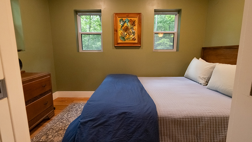 Rooted woodland cabin queen bedroom